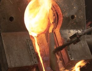 Pouring molten metal out of a crucible